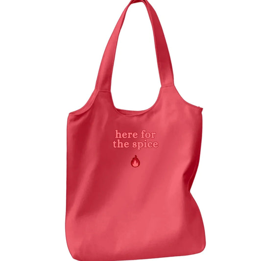 Red tote bag with 'here for the spice' text on a white background